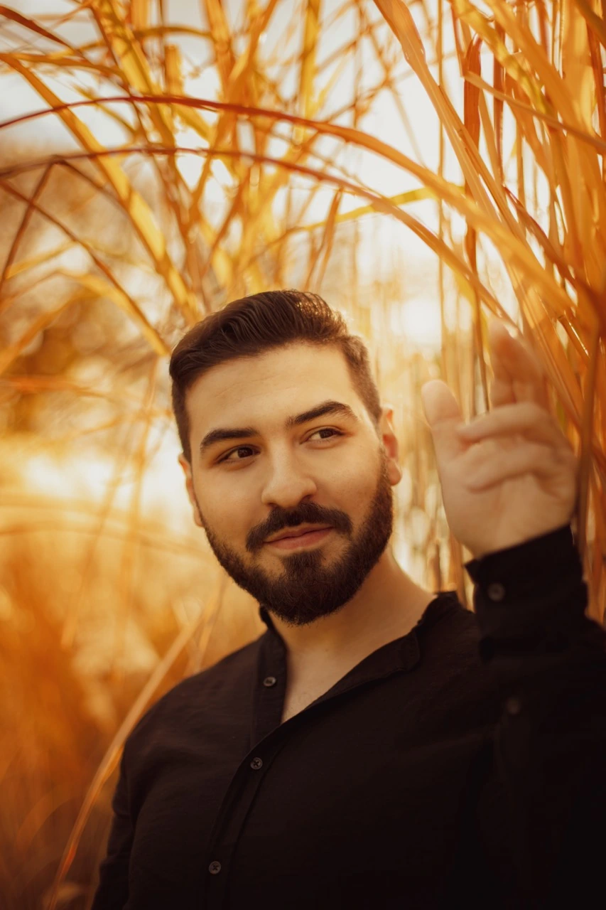 Hocine, surrounded by warm golden reeds